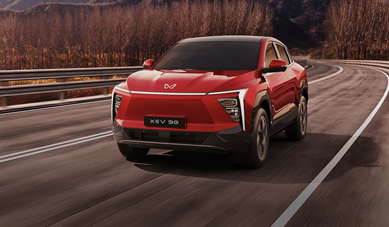 A Mahindra electric SUV on a highway A Mahindra electric SUV on a highway